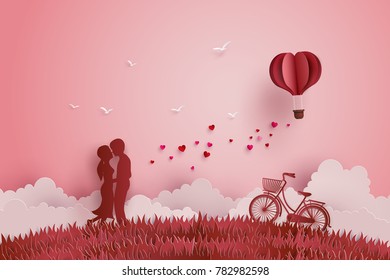 Illustration of Love and Valentine day,Lovers stand in the meadows and a paper heart shape balloon floating in the sky. Paper art and digital craft style.
