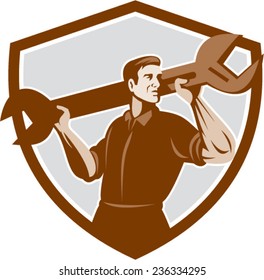 Illustration of a mechanic lifting giant spanner wrench viewed from front set inside shield crest on isolated background done in retro style. 