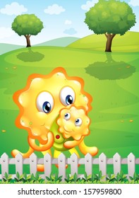 Illustration of an orange monster carrying her baby monster at the hilltop