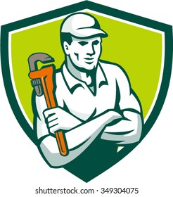 Illustration of a plumber arms crossed holding monkey wrench viewed from front set inside shield crest on isolated background done in retro style. 