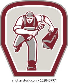 Illustration of a plumber carrying toolbox and holding monkey wrench running towards viewer set inside shield done in retro style on isolated background.