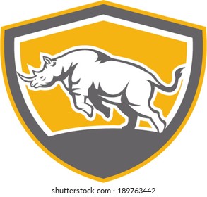 Illustration of a rhinoceros charging side view set inside shield crest shape on isolated background done in retro style.