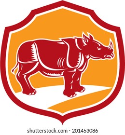 Illustration of a rhinoceros standing side view set inside shield crest on isolated background done in retro style.