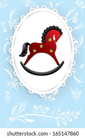 illustration of a rocking horse on a light blue background with elegant ornaments