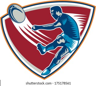 Illustration of a rugby player kicking ball front view set inside shield on isolated background done in retro woodcut style.