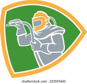 Illustration of a sandblaster worker holding sandblasting hose wearing helmet visor viewed from the side set inside shield crest on isolated background done in retro style.