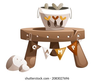 Illustration of a table with the inscription CAMP on which there is a bucket of fish.