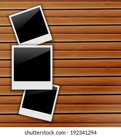 Illustration three blank photo frames on wooden background - vector