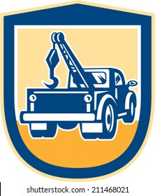 Illustration of a tow wrecker truck lorry viewed from rear set inside shield crest done in retro style on isolated background.