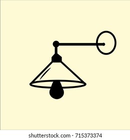 illustration of wall lamp with black light bulb on beige background.