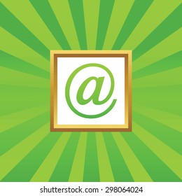 Image of at-sign in golden frame, on green abstract background