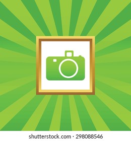 Image of camera in golden frame, on green abstract background