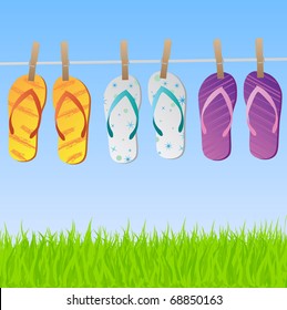 Image of a colorful scene with flip flops hanging on a clothes line with sky and grass.