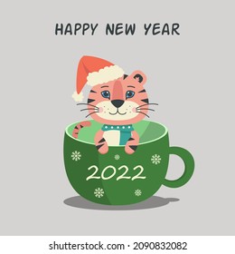 Image of a cute tiger cub in a green cup. The image is perfect for New Year and Christmas ads.