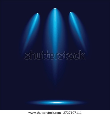 The image depicts three blue spotlights shining down from above, casting a dramatic glow on a dark stage or background. The spotlights are positioned in a triangular formation, creating a sense of depth and focus. The overall effect is one of anticipation and drama, suggesting a performance or presentation is about to take place.