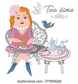 the image of the doll with a cup of tea, sitting on the couch
