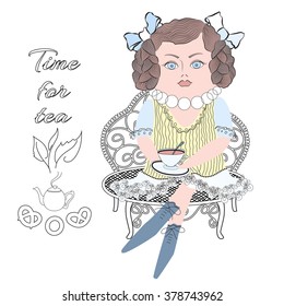 the image of the doll with a cup of tea, sitting on the couch