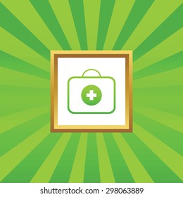 Image of first aid kit in golden frame, on green abstract background