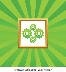 Image of four cogs in golden frame, on green abstract background