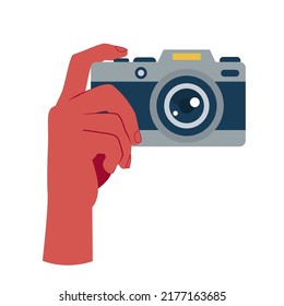 Image of hand with photo camera on empty white background.
