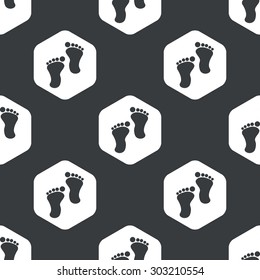 Image of human footprints in hexagon, repeated on black