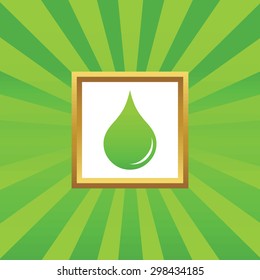 Image of liquid drop in golden frame, on green abstract background