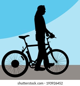 Imagen de un hombre caminando en bicicleta.