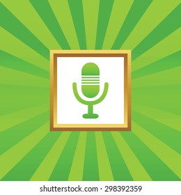 Image of microphone in golden frame, on green abstract background