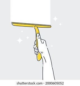 Image on the theme of cleaning and cleanliness. A mans hand is holding a window cleaning scraper.