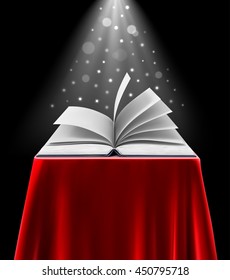 image of an open book with a beautiful light on a black background