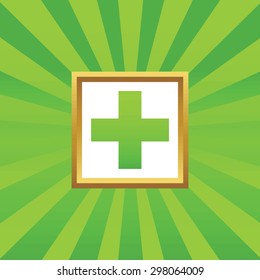 Image of plus in golden frame, on green abstract background