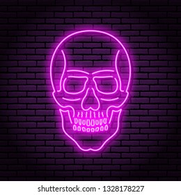 The image of the skull of neon purple lamps with a bright glow on the background of a brick wall.