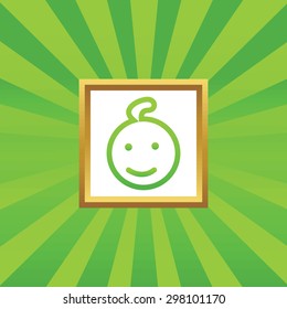 Image of smiling child face in golden frame, on green abstract background