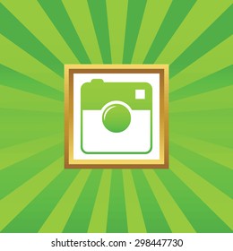 Image of square camera in golden frame, on green abstract background