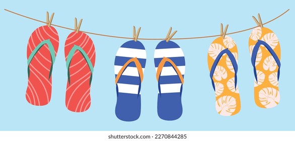 Image of various colorful flip flops hanging on a clothesline isolated on a blue background	