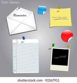 Image of various office stationary on a gray background.