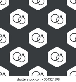 Image of wedding rings in hexagon, repeated on black