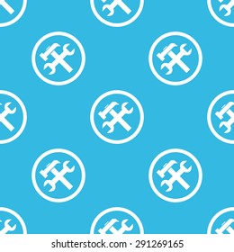 Image of wrench and hammer in circle, repeated on blue background