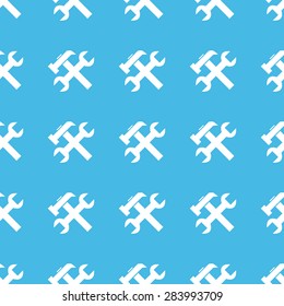 Image of wrench and hammer, repeated in straight lines on blue background