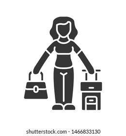 Immigrant woman glyph icon. Traveler, holidaymaker, passenger with handbag and suitcase. Travelling abroad. Immigration, tourism. Silhouette symbol. Negative space. Vector isolated illustration