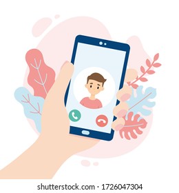 Incoming video call. Hand holding a smartphone. Cute boy making a video call. People using a video call app while social distancing.