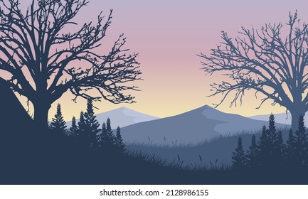 Incredible mountain view from the edge of the village at dusk with the silhouettes of the surrounding trees