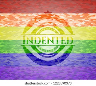 Indented on mosaic background with the colors of the LGBT flag