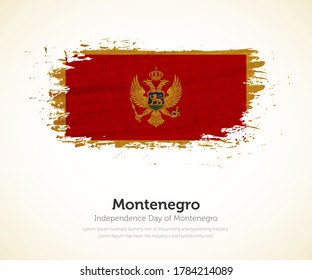 Independence day of Montenegro country. Abstract flag in shape of paint brush stroke with shiny colored background