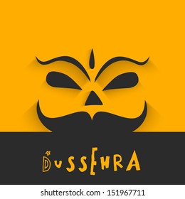 Indian festival Happy Dussehra concept with smiling face of Ravana on abstract yellow and grey background. 