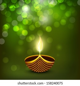 Indian festival of lights Happy Diwali greeting card or background with illuminated oil lit lamp on shiny green background. 