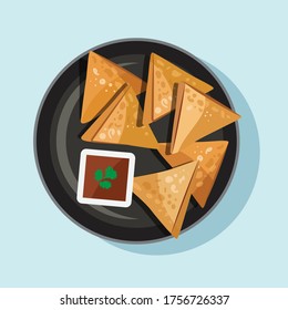 Indian Samosa on Black Plate with Sauce