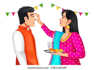 Indian woman is giving blessings to the brother by putting tika on his forehead. Both wearing traditional ethnic clothes. Celebrating Indian festival Bhai dooj