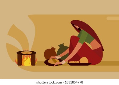 Indian woman making 'Roti' in traditional way on a fire stove