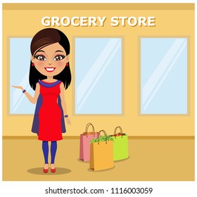 Indian woman standing outside a grocery store with her shopping bags